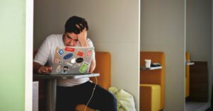 man at his laptop looking stressed | eatingdisorder.care