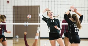 young female athletes playing volleyball